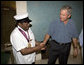 President George W. Bush shakes the hand of legendary Fats Domino, wearing a National Medal of Arts, after the President presented it Tuesday, Aug. 29, 2006, at the musician's home in the Lower 9th Ward of New Orleans. The medal was a replacement medal for the one -- originally awarded by President Bill Clinton -- that was lost in the flood waters of Hurricane Katrina. White House photo by Eric Draper