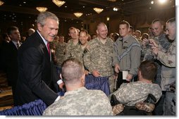 President George W. Bush is greeted by military personnel following his address on the global war on terror at the Military Officers Association of America meeting Tuesday, Sept. 5, 2006, at the Capital Hilton Hotel in Washington. President Bush spoke about the U.S. and allies strategy for combating terrorism saying "we're confronting them before they gain the capacity to inflict unspeakable damage on the world, and we're confronting their hateful ideology before it fully takes root." White House photo by Kimberlee Hewitt