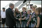 President George W. Bush is greeted Friday, Sept. 8, 2006, by members of the Mattawan Little League team from Mattawan, Mich., at Bishop International Airport in Flint, Mich. The team won all 23 games it played this summer and went on to take the 2006 Little League Softball World Series Championship. White House photo by Kimberlee Hewitt