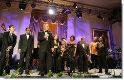 President George W. Bush stands with performers on stage in the East Room Thursday night, Sept. 14, 2006, as he offers closing remarks to guests at the Thelonious Monk Institute of Jazz dinner at the White House. White House photo by Shealah Craighead