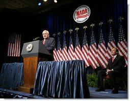 Vice President Dick Cheney delivers remarks on the economy and the global war on terror, Tuesday, September 19, 2006, at the National Automobile Dealers Association 2006 Legislative Conference in Washington, D.C. Seated on stage is Phil Brady, President of the National Automobile Dealers Association.  White House photo by Kimberlee Hewitt