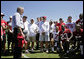 President George W. Bush talks with members of the Tampa Bay Buccaneers during his visit to the NFL team's training facility in Tampa, Fla., Thursday, Sept. 21, 2006. White House photo by Paul Morse