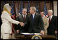 President George W. Bush shakes the hand of Ambassador Hunaina bint Sultan Al-Mughairy, of the Sultanate Oman to the United States, after signing H.R. 5684, the United States-Oman Free Trade Agreement Implementation Act Tuesday, Sept. 26, 2006, in the Dwight D. Eisenhower Executive Office Building. White House photo by Kimberlee Hewitt