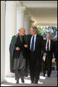 President George W. Bush walks with President Hamid Karzai of the Islamic Republic of Afghanistan along the colonnade in the Rose Garden Tuesday, Sept. 26, 2006. White House photo by David Bohrer