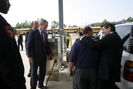 President George W. Bush observes an alternative fueling demonstration with Hoover Police Department Officer Reggie Parker, center, being embraced by Alabama Governor Bob Riley, Thursday, Sept. 28, 2006, during President Bush’s visit to the Hoover Public Safety Center in Hoover, Ala. The city has just opened an alternative fueling station to provide E85 (ethanol) and biodiesel fuels for public agency vehicles. White House photo by Paul Morse