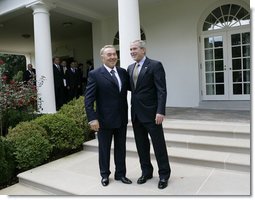 President George W. Bush walks with Kazakhstan President Nursultan Nazarbayev out to the Rose Garden at the White House, Friday, Sept. 29, 2006, following their meeting in the Oval Office.  White House photo by Eric Draper