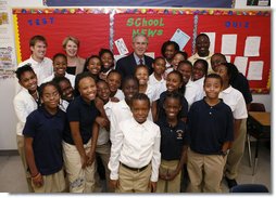 President George W. Bush and U.S. Secretary of Education Margaret Spellings pose for a photo with students during their visit Thursday, Oct. 5, 2006, to the Woodridge Elementary and Middle Campus in Washington, D.C.  White House photo by Paul Morse