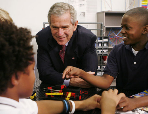 President George W. Bush talks with students during his visit Thursday, Oct. 5, 2006, in the SmartLab of the Woodridge Elementary and Middle Campus in Washington, D.C., where students demonstrated various math, science and technology projects. White House photo by Paul Morse