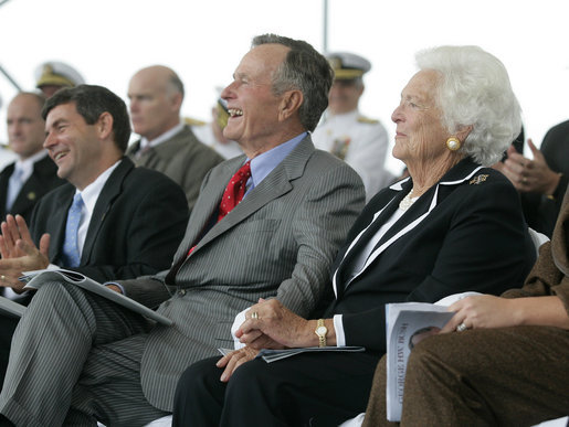 Former President George H. W. Bush and First Lady Barbara Bush react during remarks by President George W. Bush during the Christening Ceremony for the George H.W. Bush (CVN 77) in Newport News, Virginia, Saturday, Oct. 7, 2006. White House photo by Eric Draper