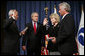 President George W. Bush attends the ceremonial swearing-in of Mary Peters as the 15th U.S. Secretary of Transportation, Tuesday, Oct. 17, 2006 at the Department of Transportation in Washington, D.C., as White House Chief of Staff Josh Bolten administers the oath of office and Peter’s husband, Terryl "Terry" Peters, Sr. holds the bible. White House photo by Paul Morse