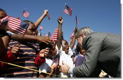 President George W. Bush greets flag-waving students at the Waldo C. Falkener Elementary School Wednesday, Oct. 18, 2006, in Greensboro, N.C., where he delivered remarks on the No Child Left Behind Act.  White House photo by Paul Morse