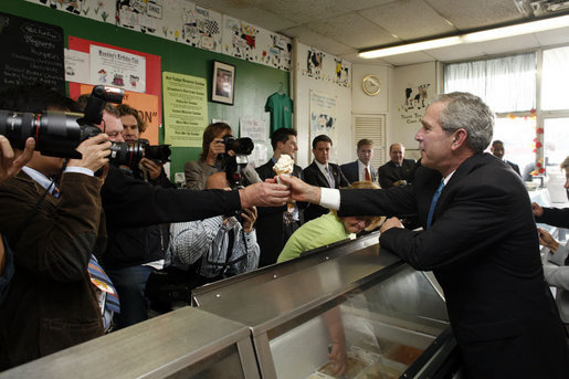 President George W. Bush is handed an ice cream cone during a visit to Manning's Ice Cream and Milk in Clarks Summit, Pa., Thursday, Oct. 19, 2006. White House photo by Paul Morse