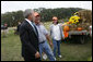 President George W. Bush talks with pumpkin roadside stand owner Bill Gaulmyer and Thina Patterson in Richmond, Va., Thursday, Oct. 19, 2006. White House photo by Paul Morse