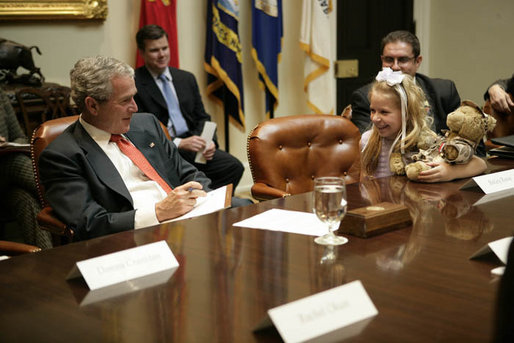 President George W. Bush listens to Bailey Reese, 10, founder of Hero Hugs, which sends care packages to our troops serving overseas, during a meeting with organizations that support the U.S. Military in Iraq and Afghanistan in the Roosevelt Room, Friday, October 20, 2006. White House photo by Eric Draper