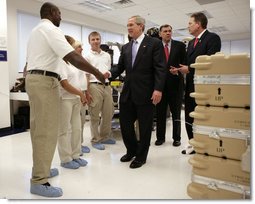 President George W. Bush shakes hands with employees at Gyrocam Systems in Sarasota, Fla., Tuesday, Oct. 24, 2006, during a visit that highlighted technology to help soldiers fight the war on terrorism. White House photo by Eric Draper