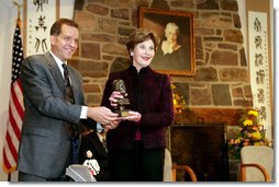 John Long, Chairman of the Board of Directors, Pearl S. Buck International, presents Mrs. Laura Bush with the 2006 Pearl S. Buck Woman of the Year award Tuesday, October 24, 2006, at the Pearl S. Buck House in Perkasie, Pennsylvania. The Pearl S. Buck award is given to honor women who make outstanding contributions in the areas of cross-cultural understanding, humanitarian outreach, and improving the life and expanding opportunities for children around the world. White House photo by Shealah Craighead
