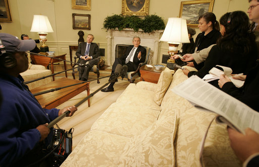 President George W. Bush speaks to reporters as he sits with NATO Secretary-General Jaap de Hoop Scheffer in the Oval Office Friday, Oct. 27, 2006. White House photo by Kimberlee Hewitt