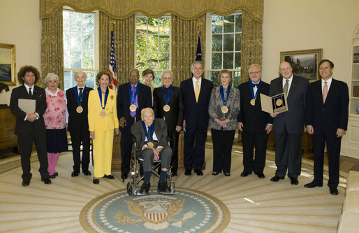 President George W. Bush and Mrs. Laura Bush stand with the recipients of the 2006 National Medal of Arts in the Oval Office Thursday, Nov., 9, 2006. Pictured from left, they are: Ben Jaffe and his mother Sandra Jaffe, director and co-founder of the Preservation Hall Jazz Band; Literary Translator Gregory Rabassa; Dancer Cyd Charisse; Photographer Roy DeCarava; Industrial Designer Viktor Schreckengost; Musician Dr. Ralph Stanley; Arts patron Billie Holladay; Composer William Bolcom; Interlochen Center for the Arts CEO Jeffrey Kimpton; and NEA Chairman Dana Gioia. White House photo by Paul Morse