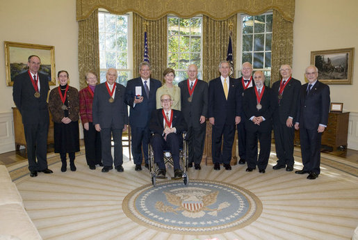 President George W. Bush and Mrs. Laura Bush stand with the 2006 National Humanities Medal recipients in the Oval Office Thursday, Nov., 9, 2006. Pictured from left, they are: Mark Noll, historian of religion; Mary Lefkowitz, classicist; Meryle Secrest, biographer; Bernard Lewis, Middle Eastern scholar; John Raisian senior fellow and director of the Hoover Institution; Robert Fagles, translator and classicist; Nickolas Davatzes, historian; Kevin Starr, historian; Fouad Ajami, Middle Eastern studies scholar; James Buchanan, economist; and NEH chairman Bruce Cole. White House photo by Paul Morse