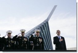 President George W. Bush joins, from left, U.S. Marine Corps Lt. Gen. James Amos; Chairman of the Joint Chiefs of Staff General Peter Pace and Commandant of the Marine Corps, General Michael Hagee, during the National Anthem at the dedication ceremony of the National Museum of the Marine Corps Friday, Nov. 10, 2006, in Quantico, Va. White House photo by Paul Morse