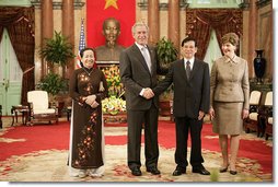 President George W. Bush and Mrs. Laura Bush join Viet President Nguyen Minh Triet and Mrs. Tran Thi Kim Chi in the Great Hall of the Presidential Palace Friday, Nov. 17, 2006, after arriving in Hanoi for the 2006 APEC Summit.  White House photo by Eric Draper