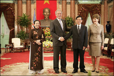 President George W. Bush and Mrs. Laura Bush join Viet President Nguyen Minh Triet and Mrs. Tran Thi Kim Chi in the Great Hall of the Presidential Palace Friday, Nov. 17, 2006, after arriving in Hanoi for the 2006 APEC Summit. White House photo by Eric Draper