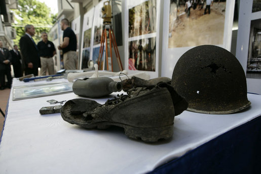 A recovered helmet, canteen and shoe are among articles on display Saturday, Nov. 18, 2006, as President George W. Bush visits the Joint POW/MIA Accounting Command in Hanoi. White House photo by Eric Draper
