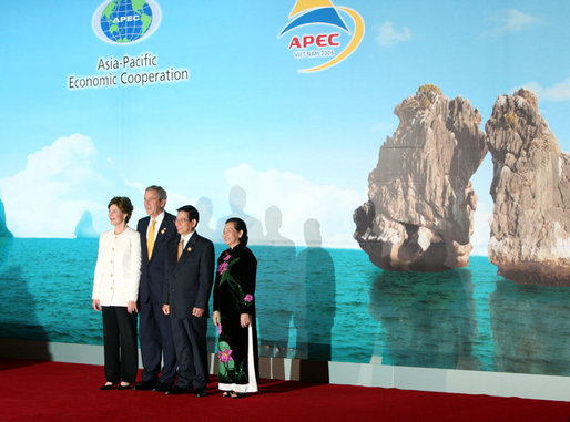 President George W. Bush and Mrs. Laura Bush stand with Viet President Nguyen Minh Triet and Mrs. Tran Thi Kim Chi after arriving Saturday, Nov. 18, 2006, at the National Convention Center in Hanoi for the APEC gala dinner and cultural performance. White House photo by Eric Draper