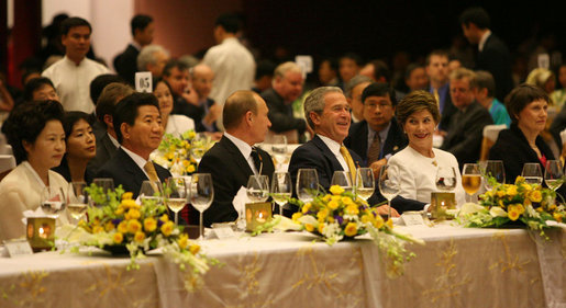 President George W. Bush and Mrs. Laura Bush enjoy the APEC gala dinner and cultural performance Saturday, Nov. 18, 2006, at the National Convention Center in Hanoi. They are seated with President Vladimir Putin of Russia, and President Roh Moo-hyun of the Republic of Korea, left, and Prime Minister Helen Clark of New Zealand, right. White House photo by Eric Draper