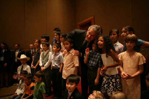 President George W. Bush joins kids of U.S. Embassy staff for a photo at the Sheraton Hanoi Saturday, Nov. 18, 2006. White House photo by Paul Morse