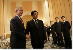President George W. Bush is greeted by President Hu Jintao of China at the Hanoi Daewoo Hotel in Hanoi after his arrival Sunday, Nov. 19, 2006, for bilateral talks. President Bush told President Hu, "China is a very important nation, and the United States believes strongly that by working together, we can help solve problems."  White House photo by Eric Draper