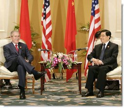 President George W. Bush and President Hu Jintao of China pause for photos after their bilateral talks Sunday, Nov. 19, 2006, at the Hanoi Daewoo Hotel in Hanoi. White House photo by Eric Draper