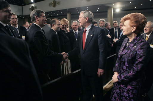 President George W. Bush greets the audience after delivering remarks Tuesday, Nov. 28, 2006, with Latvia President Vaira Vike-Freiberga at Latvia University in Riga. White House photo by Eric Draper