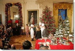 Mrs. Laura Bush and White House Chef Cris Comerford, center, explain the holiday reception menu to the press in the State Dining Room Thursday, Nov. 30, 2006. White House photo by Shealah Craighead