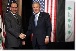President George W. Bush and Prime Minister Nouri al-Maliki shake hands after a joint press availability Thursday, Nov. 30, 2006, in Amman, Jordan. The leaders later issued a joint statement in which they said they were, "Pleased to continue our consultations on building security and stability in Iraq."  White House photo by Paul Morse