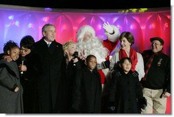 President George W. Bush and Laura Bush join entertainers Eartha Kitt, left, and Cathy Rigby, center, along with Santa Claus, invited children and The Singing Angels choir director Charles Eversole, right, on stage Thursday, Dec. 7, 2006, at the 2006 Christmas Pageant of Peace and the 83rd lighting of the National Christmas Tree on the Ellipse in Washington, D.C.  White House photo by Kimberlee Hewitt