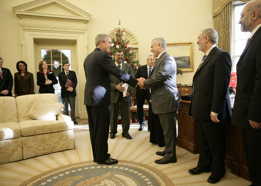 President George W. Bush shakes the hand of Vice President Tariq al-Hashemi of Iraq as they near the end of their Oval Office visit Tuesday, Dec. 12, 2006. The President told Vice President Hashemi, "Our objective is to help the Iraqi government deal with the extremists and killers, and support the vast majority of Iraqis who are reasonable people who want peace." White House photo by Eric Draper