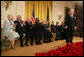 Fellow recipients of the 2006 Presidential Medal of Freedom applaud as President George W. Bush bestows the honor on David McCullough during ceremonies Friday, Dec. 15, 2006, at the White House. Said the President, "This chronicler of other times is one of the eminent Americans of our time. The nation owes a debt of gratitude to a fine author and a fine man." White House photo by Shealah Craighead