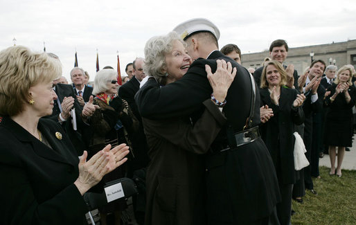 Joyce Rumsfeld, wife of Secretary of Defense Donald Rumsfeld, embraces General Peter Pace, Chairman of the Joint Chiefs of Staff, after she was presented with a medal in recognition of her service Friday, Dec. 15, 2006, during an Armed Forces Full Honor Review in honor of her husband. Mrs. Lynne Cheney looks on at left. White House photo by Eric Draper