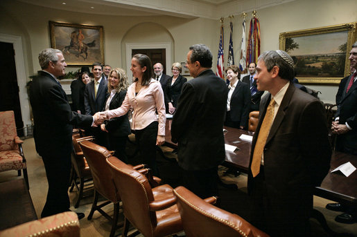 President George W. Bush greets Maya Pick, a student from the University of Virginia, during a meeting with Jewish leaders from the higher education community in the Roosevelt Room Monday, Dec. 18, 2006. White House photo by Eric Draper