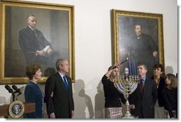 President George W. Bush and Laura Bush watch as Ariel Cohen, 14, lights the Menorah on the fourth night of Hanukkah during the annual White House Hanukkah reception Monday, Dec. 18, 2006. Pictured at right are Ariel's parents, Dan and Rachel Cohen, and sister Alison, 11.  White House photo by Shealah Craighead