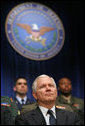 Robert Gates listens to President George W. Bush speak during his swearing-in ceremony as Secretary of Defense at the Pentagon Monday, Dec. 18, 2006. White House photo by Eric Draper