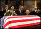 Former first lady Betty Ford kneels at the casket of her husband, former President Gerald R. Ford, in the U.S. Capitol rotunda during the State Funeral ceremony, Saturday, December 30, 2006. Accompanying Mrs. Ford are her children, from left, John G. Ford, Susan Ford Bales, Michael Ford and Steven Ford. White House photo by David Bohrer