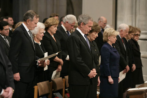 President George W. Bush and Laura Bush stand during the State Funeral for former President Gerald R. Ford at the National Cathedral in Washington, D.C., January 2, 2007. Standing back row left, former President George H.W. Bush, former first lady Barbara Bush, Dora Bush Koch, and former President Bill Clinton. Front row, left to right, Mrs. Lynne Cheney, former President Jimmy Carter, former first lady Rosalynn Carter, and former first lady Nancy Reagan White House photo by Eric Draper