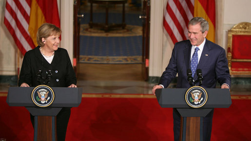 President George W. Bush and German Chancellor Angela Merkel react to a reporter’s question during a joint news conference at the White House, Thursday, Jan. 4, 2006, where they answered questions on Iraq, the Middle East and U.S.-European economic issues. White House photo by Paul Morse