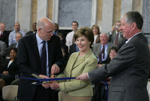 Mrs. Laura Bush is joined by U.S. Secretary of the Treasury Henry M. Paulson, Jr., left, and Richard C. Cote, curator, U.S. Department of the Treasury, as she cuts the ceremonial ribbon to mark the completion of the first major restoration at the U.S. Treasury Building, Thursday, Jan. 11, 2007, in Washington, D.C. White House photo by Shealah Craighead