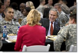 President George W. Bush talks with U.S. troops and their families over lunch during his visit to Fort Benning, Ga., Thursday, Jan. 11, 2007.  White House photo by Eric Draper