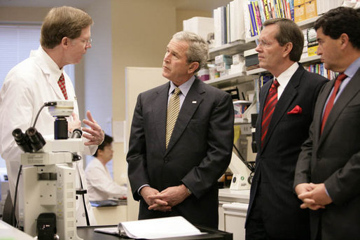 President George W. Bush listens to Dr. Marston Linehan, left, chief of Urological Oncology, as he tours a cancer lab at the National Institutes of Health in Bethesda, Md., Wednesday, Jan. 17, 2007. Also pictured are Health and Human Services Secretary Mike Leavitt, right, and NIH Director Dr. Elias Zerhouni, far right. White House photo by Eric Draper