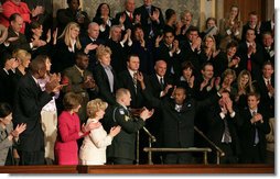 Wesley Autrey receives a standing ovation as President Bush recognizes him during his State of the Union Address at the U.S. Capitol Tuesday evening, Jan. 23, 2007. 'Three weeks ago, Wesley Autrey was waiting at a Harlem subway station with his two little girls, when he saw a man fall into the path of a train,' said President Bush. 'With seconds to act, Wesley jumped onto the tracks, pulled the man into the space between the rails, and held him as the train passed right above their heads. He insists he's not a hero. He says: 'We got guys and girls overseas dying for us to have our freedoms. We have got to show each other some love.' There is something wonderful about a country that produces a brave and humble man like Wesley Autrey.' White House photo by Shealah Craighead