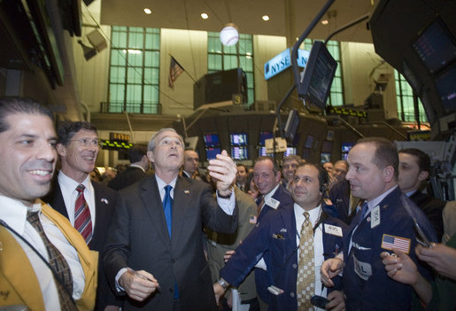 President George W. Bush tosses a baseball in the air as he greets traders Wednesday, Jan. 31, 2007, on the floor of the New York Stock Exchange. The unscheduled visit marked only the second visit by a sitting president during regular Exchange hours. White House photo by Paul Morse